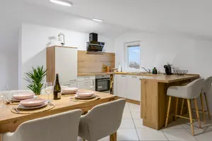 A staged dining area and kitchen, representative of Lumiora's Airbnb turnover cleaning (stock photo)
