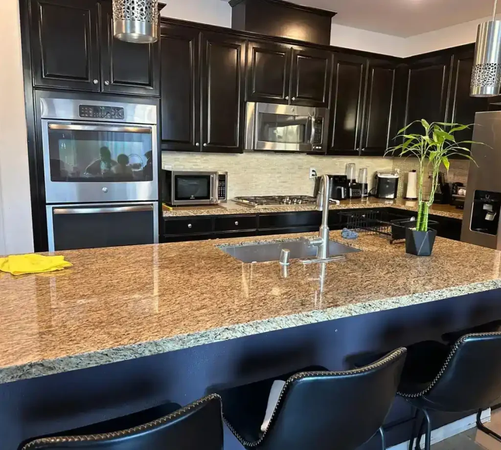 A clean granite kitchen island after a Lumiora house cleaning visit